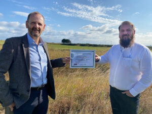 From left, Phil Davie, Nucore COO presents the Carbon Neutral Certificate to Stuart Insch, Nucore HSEQ Manager and Chair of the CSR team